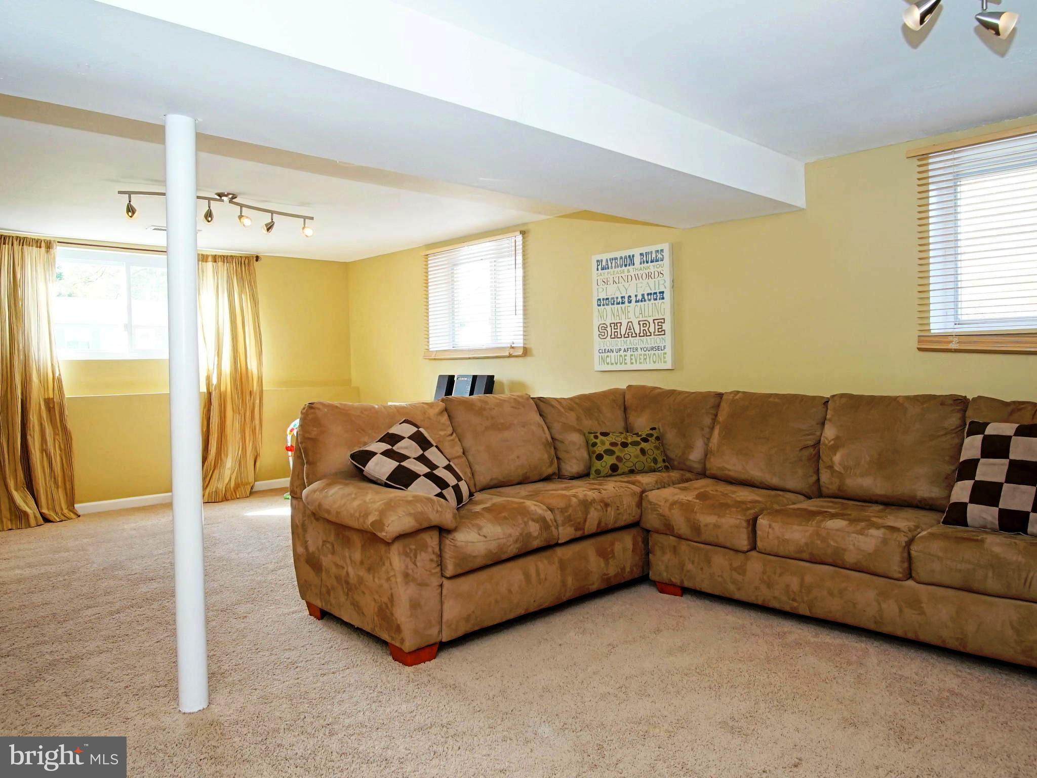 6208 Collinsway Road Baltimore, MD 21228 - Photo 12 of 22 a living room with furniture and a large window