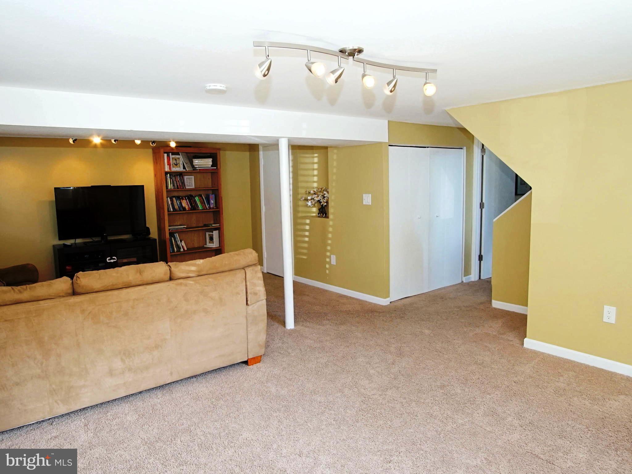 6208 Collinsway Road Baltimore, MD 21228 - Photo 15 of 22 a view of a livingroom with furniture and a flat screen tv