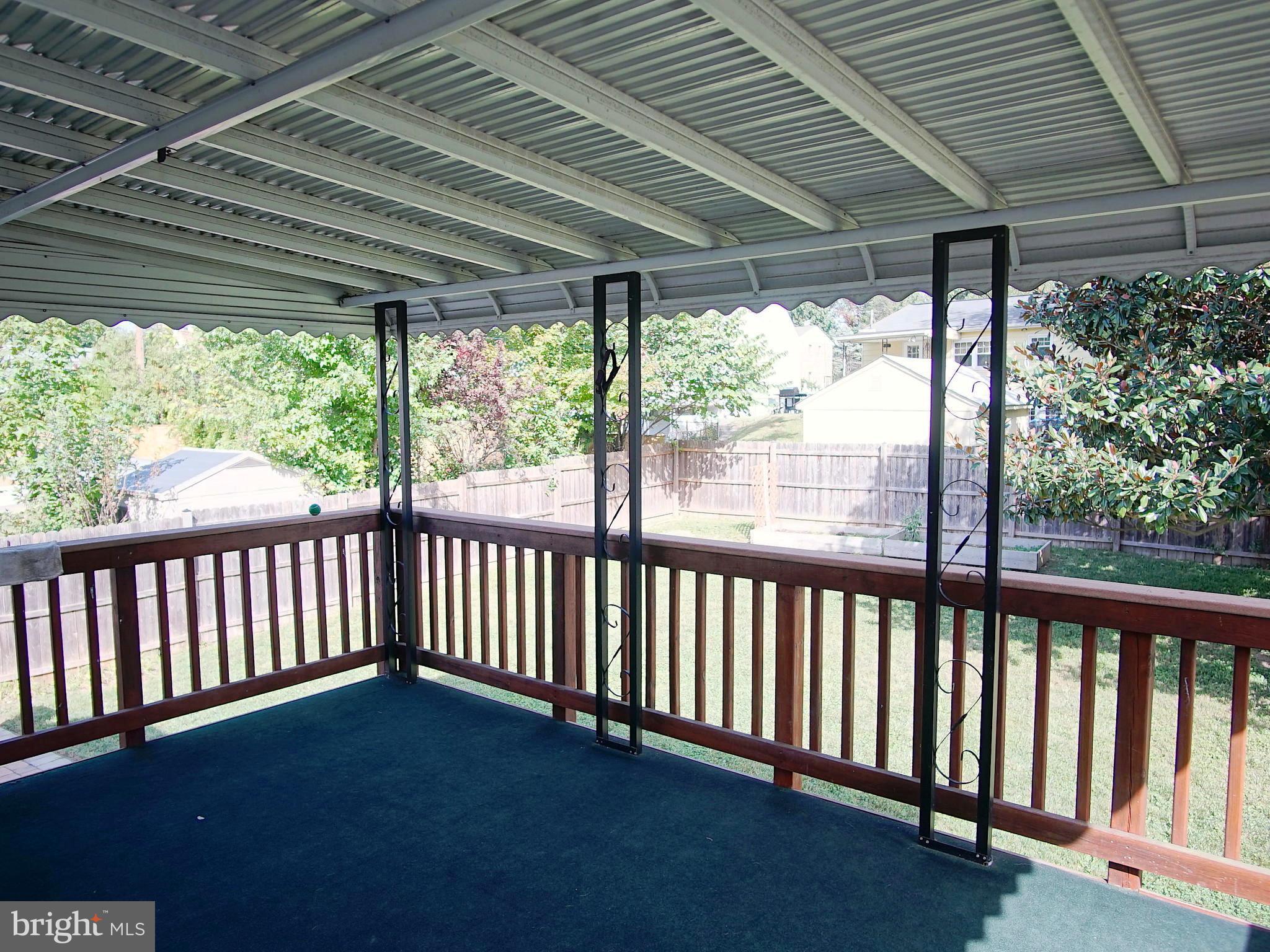 6208 Collinsway Road Baltimore, MD 21228 - Photo 17 of 22 a porch with a table in the patio