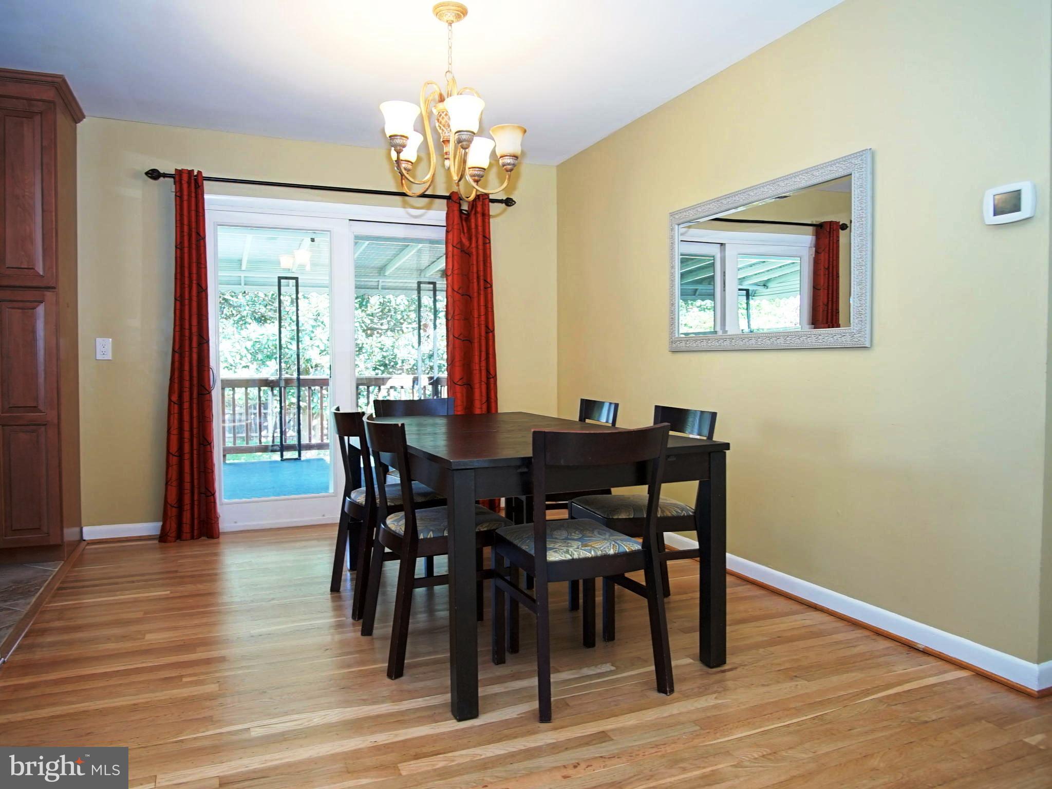 6208 Collinsway Road Baltimore, MD 21228 - Photo 4 of 22 a view of a dining room with furniture window and wooden floor