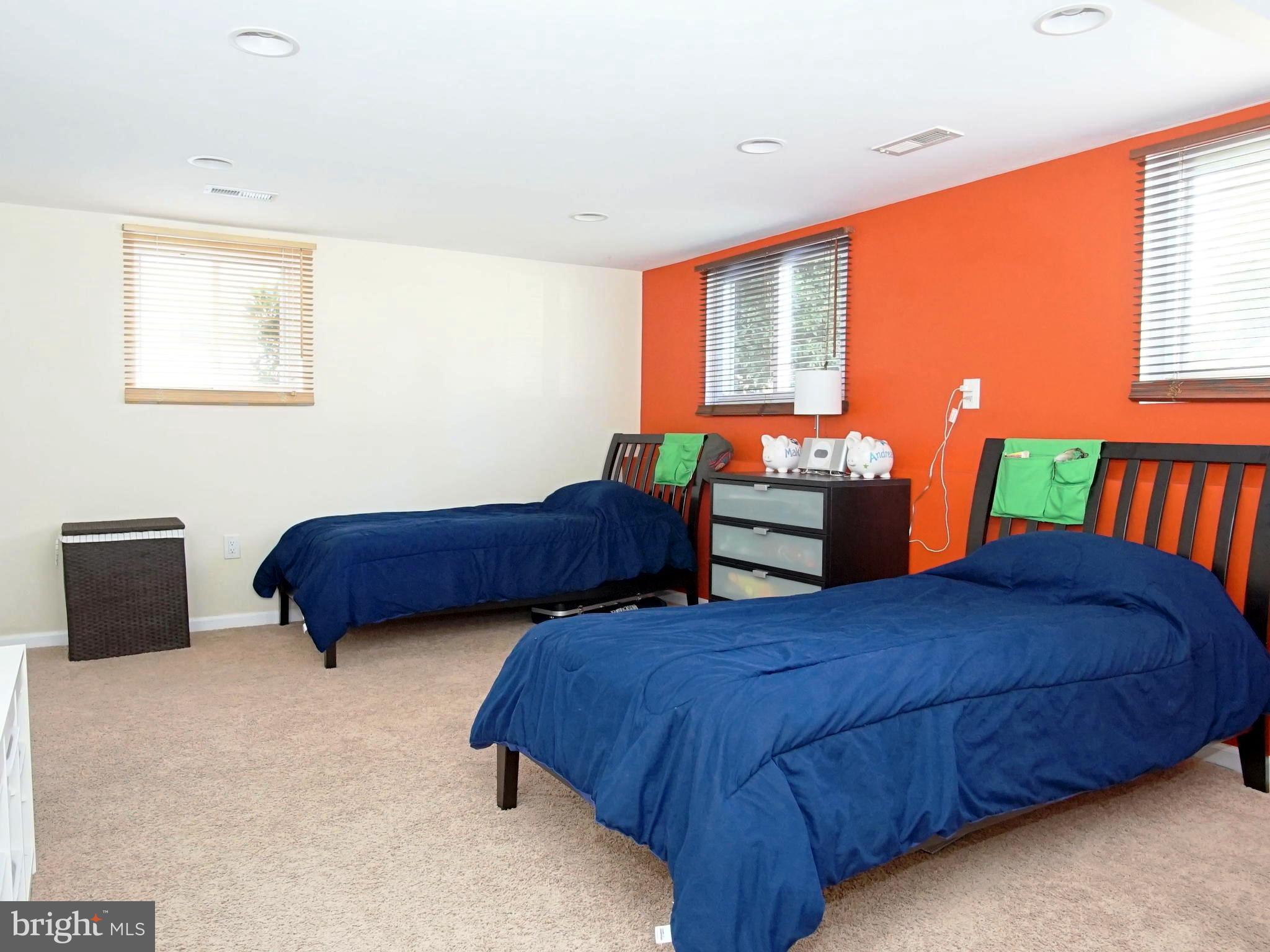 6208 Collinsway Road Baltimore, MD 21228 - Photo 10 of 22 a bedroom with two beds and a large window
