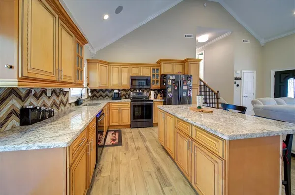 a kitchen with stainless steel appliances granite countertop a sink and counter space