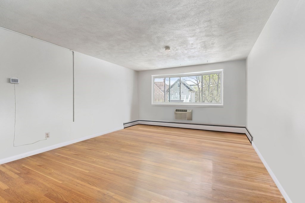 20 Radcliffe Road, Unit 304 Boston, MA 02134 - Photo 14 of 24 wooden floor in an empty room with a window