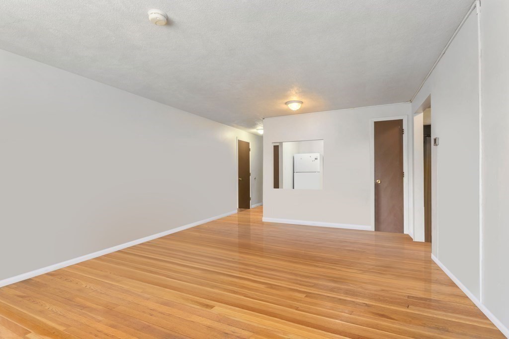 20 Radcliffe Road, Unit 304 Boston, MA 02134 - Photo 15 of 24 a view of an empty room with wooden floor