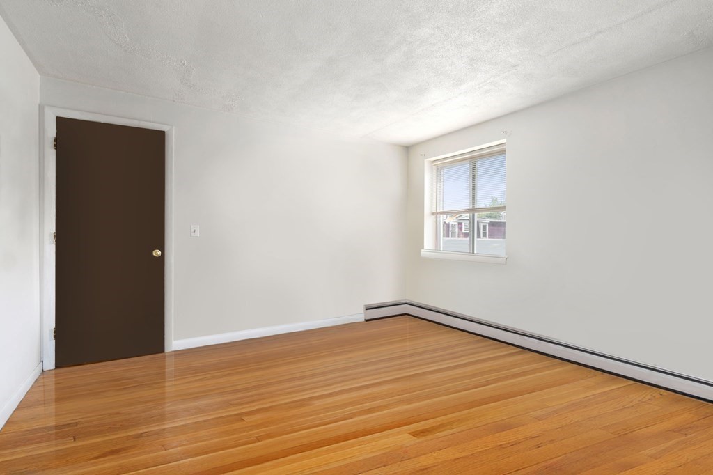 20 Radcliffe Road, Unit 304 Boston, MA 02134 - Photo 18 of 24 a view of an empty room with wooden floor