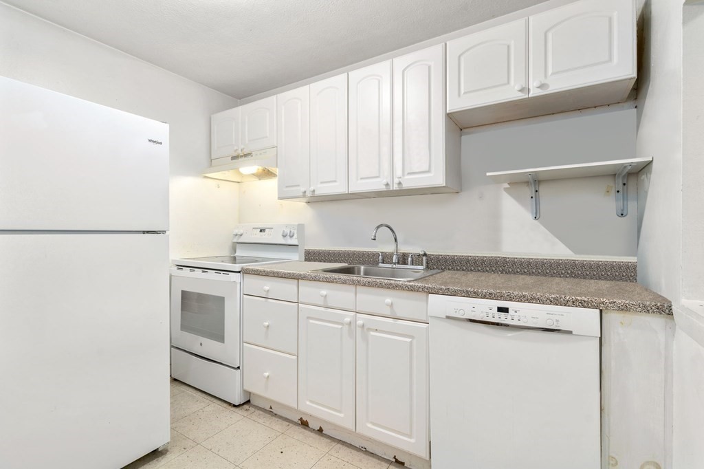 20 Radcliffe Road, Unit 304 Boston, MA 02134 - Photo 5 of 24 a kitchen with granite countertop white cabinets and white appliances