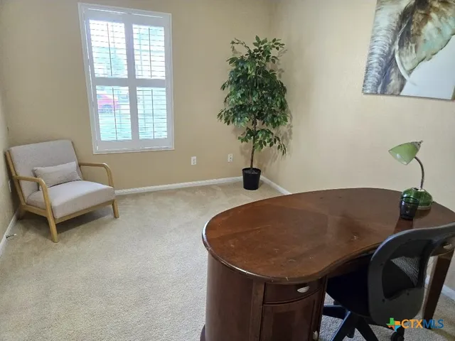 a dining room with furniture and potted plants