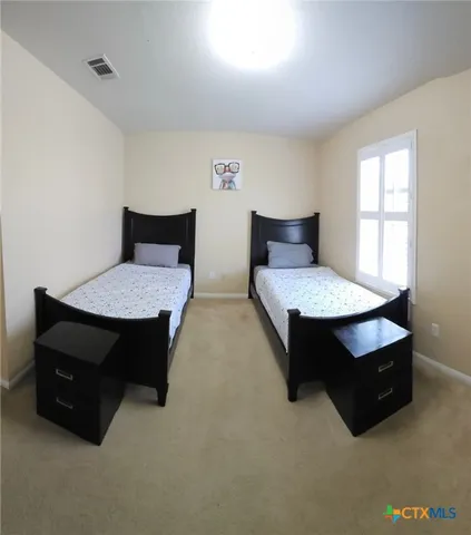 a living room with furniture and a lamp