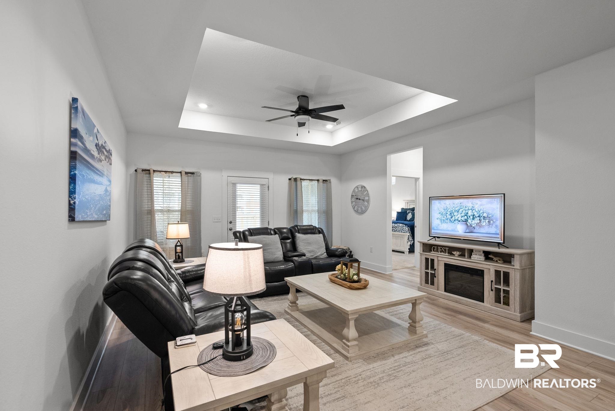 9899 Willet Way Foley, AL 36535 - Photo 6 of 37 Spacious living area featuring a tray ceiling with recessed lighting and a ceiling fan