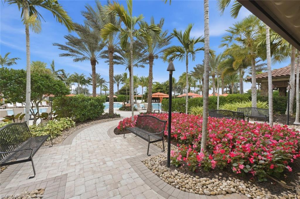 9365 Pocida Court, Unit 202 Naples, FL 34119 - Photo 32 of 40 a view of a backyard with sitting area