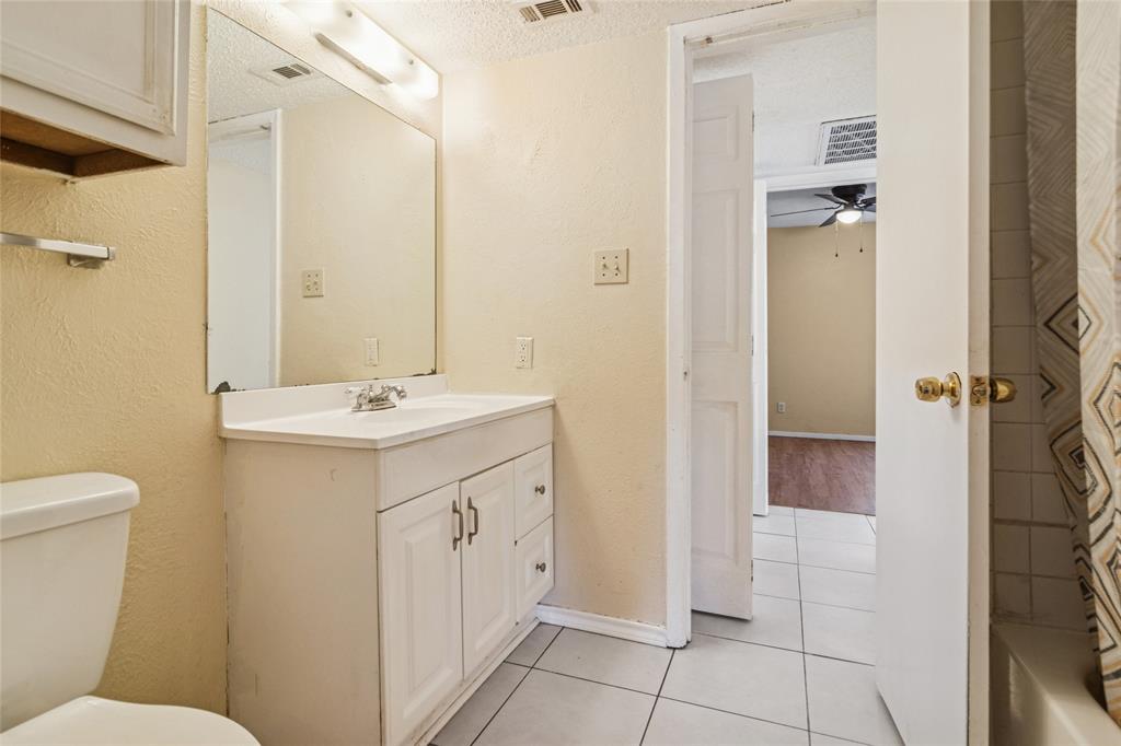 2111 East Belt Line Road, Unit 132C Richardson, TX 75081 - Photo 11 of 15 a bathroom with a sink a toilet and shower
