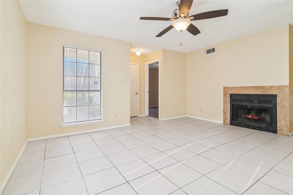 2111 East Belt Line Road, Unit 132C Richardson, TX 75081 - Photo 3 of 15 a view of an empty room with a fireplace