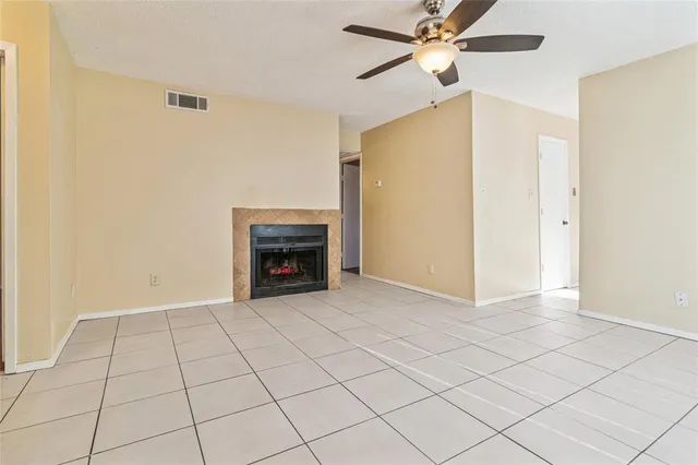 a view of an empty room with a fireplace