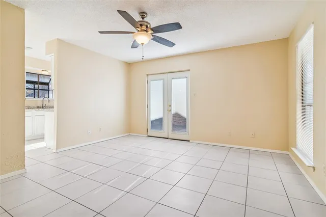 an empty room with closet and windows