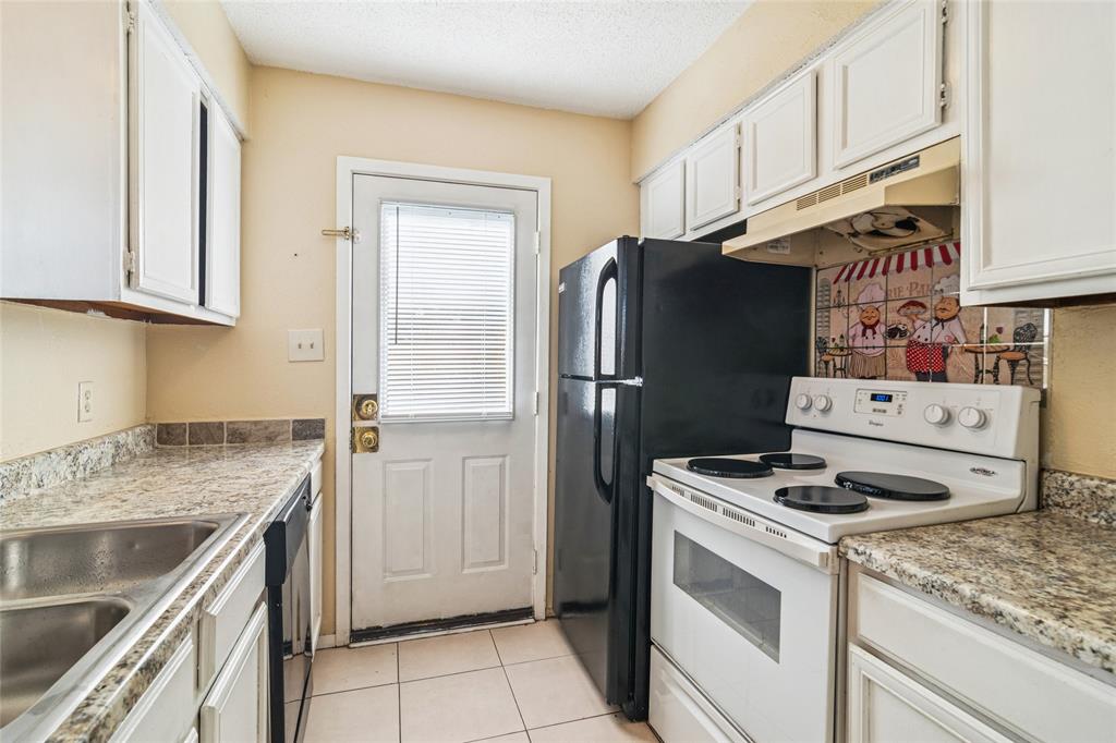 2111 East Belt Line Road, Unit 132C Richardson, TX 75081 - Photo 8 of 15 a kitchen with a stove cabinets and refrigerator