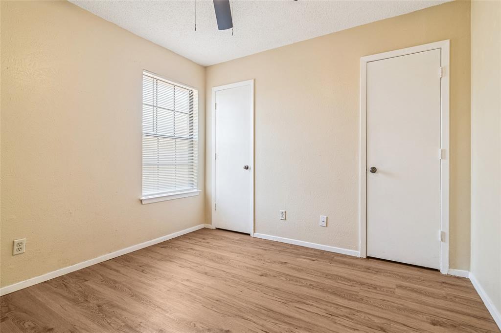 2111 East Belt Line Road, Unit 132C Richardson, TX 75081 - Photo 10 of 15 an empty room with wooden floor and windows