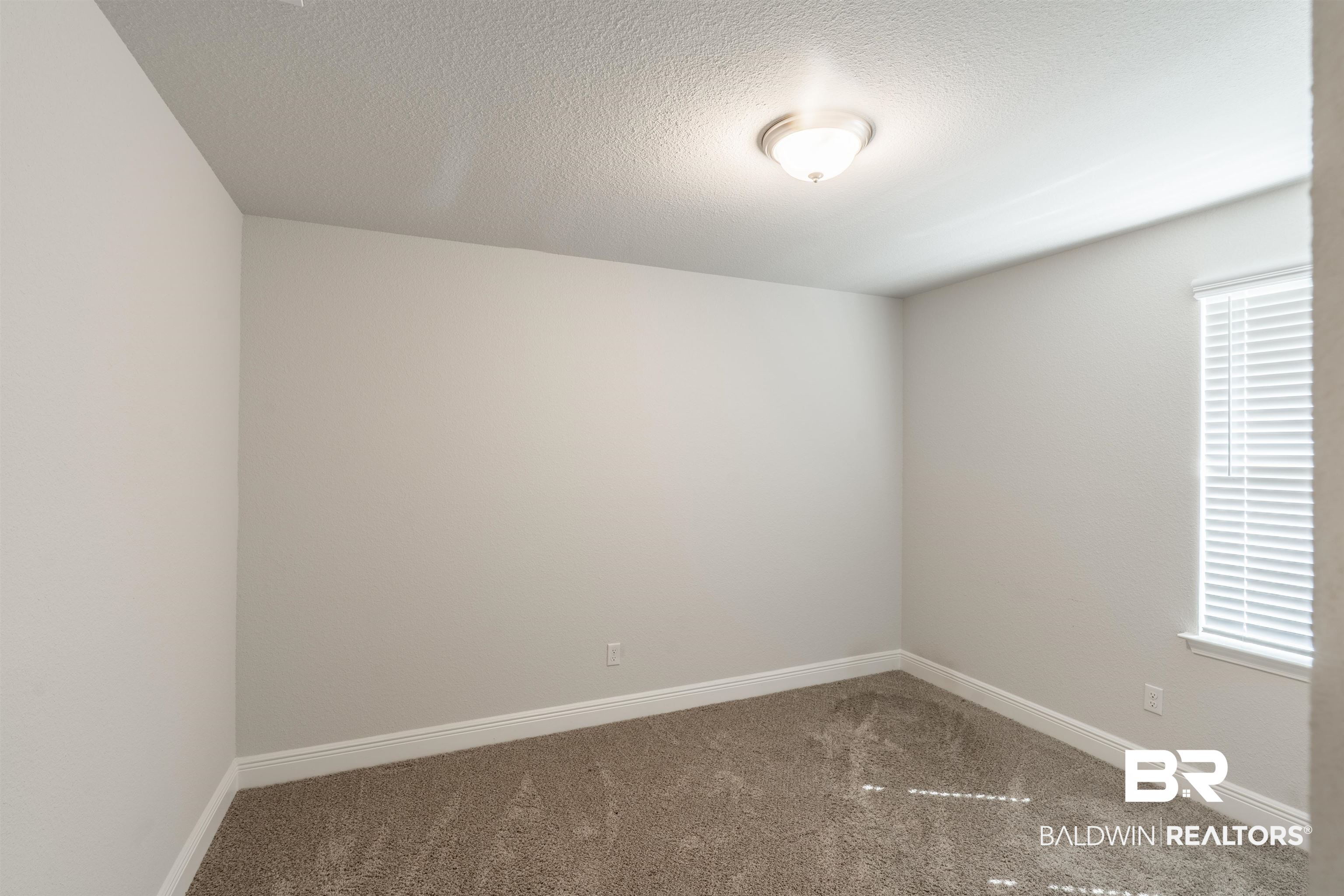 1906 Stonepine Drive South Semmes, AL 36575 - Photo 15 of 30 Carpeted spare room featuring baseboards and a textured ceiling