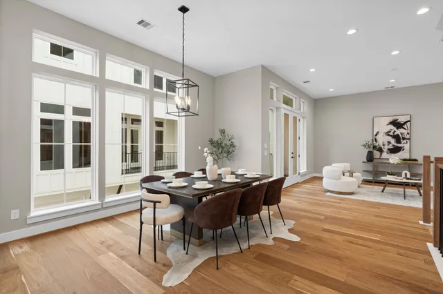 a kitchen with white cabinets and chairs