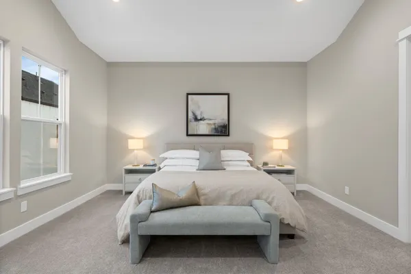 a bedroom with a bed and a lamp