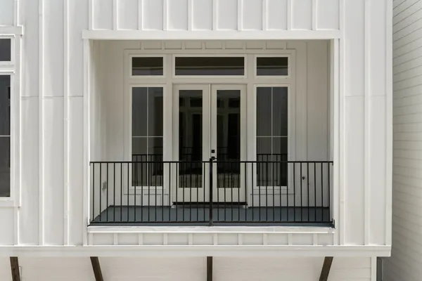 a view of a hallway with wooden floor and entryway