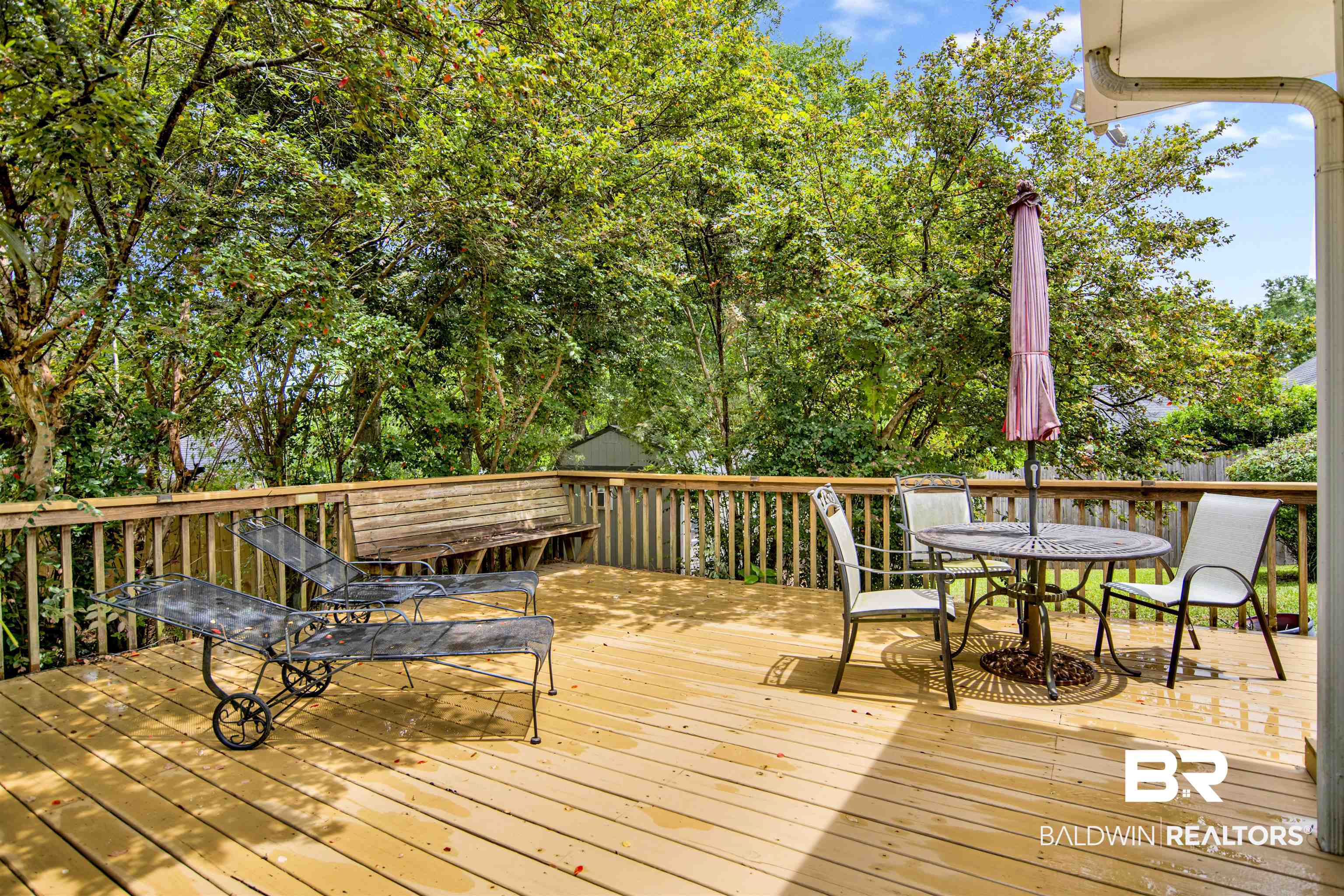 107 Virginia Circle Daphne, AL 36526 - Photo 32 of 47 Spacious exterior wood deck with a built-in wooden bench and wooden railing