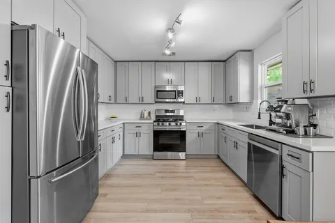 a kitchen with a refrigerator sink and microwave