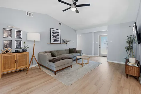 a living room with furniture and a wooden floor