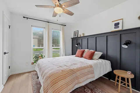 a bedroom with a bed and a chandelier
