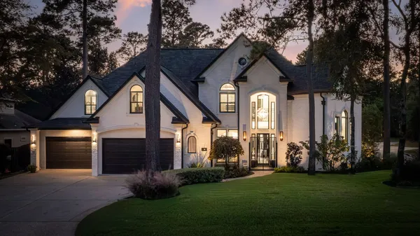 a front view of house with yard and green space