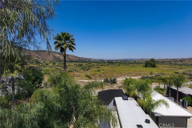 a view of a patio with a table chairs and a fire pit