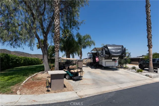 a view of swimming pool with outdoor seating and green space