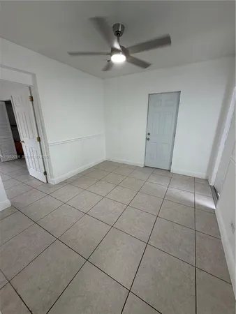 a view of an empty room and staircase