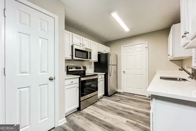 a kitchen with a refrigerator stove and a sink
