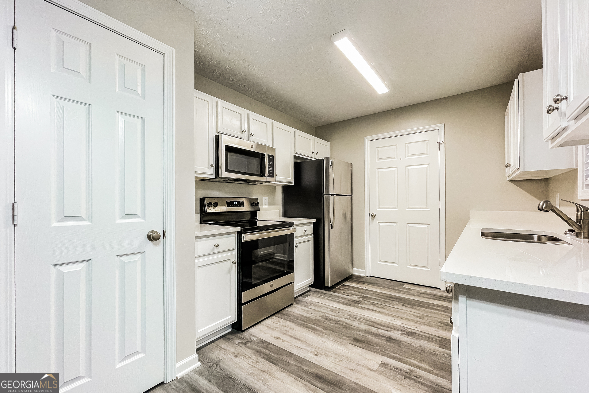 107 Johnny Lane Dallas, GA 30132 - Photo 3 of 17 a kitchen with a refrigerator stove and a sink