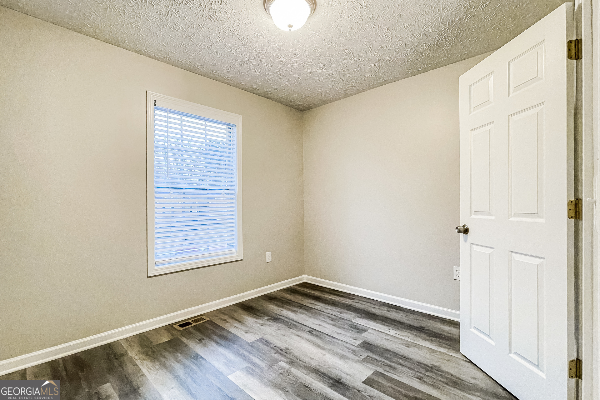 107 Johnny Lane Dallas, GA 30132 - Photo 8 of 17 a view of empty room with wooden floor