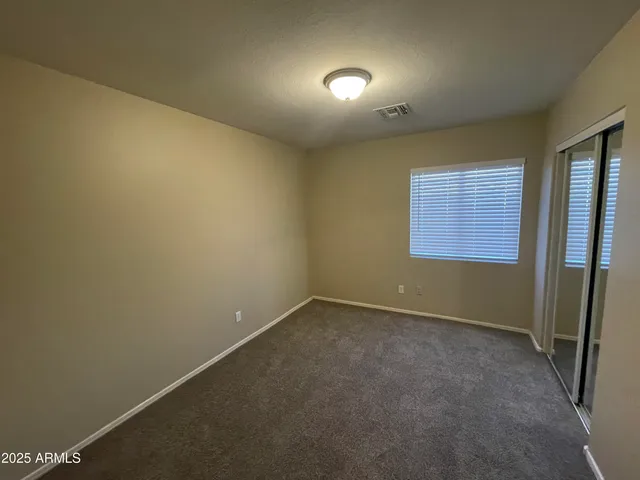 an empty room with a empty space and windows