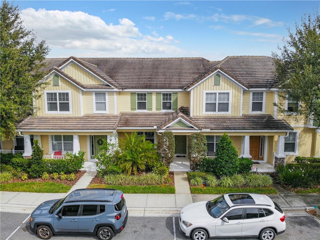 a car parked in front of a house with a yard