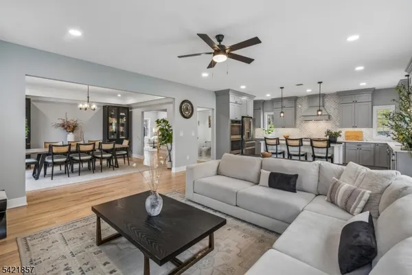 a living room with furniture and a view of kitchen