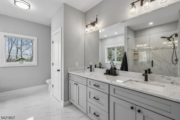 a bathroom with double sink and a mirror