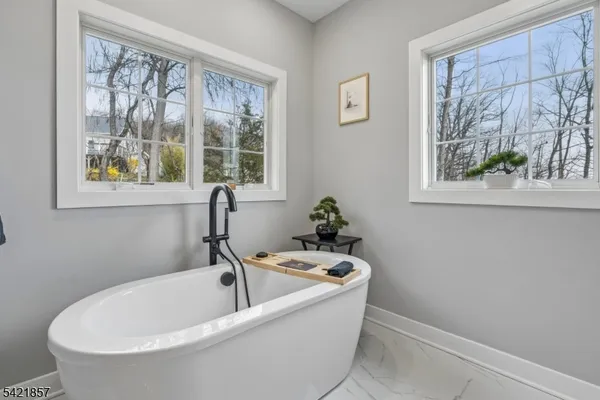 a white bath tub sitting next to a window