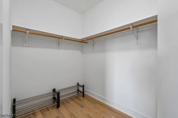 a room with a bench and wooden floor