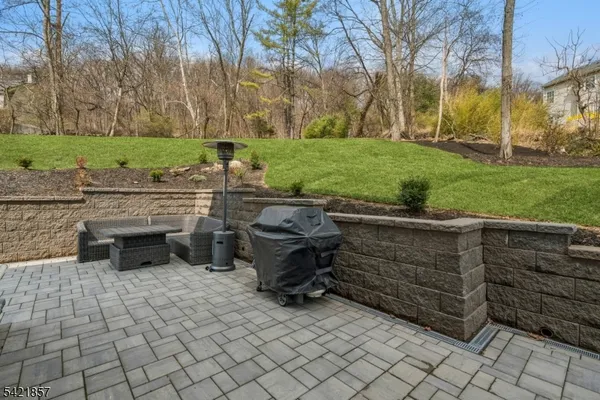 a view of backyard with seating space and trees