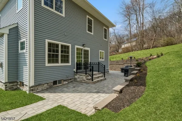 a view of a house with a yard and sitting area