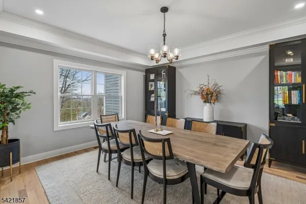 a dining room with furniture a rug and a chandelier
