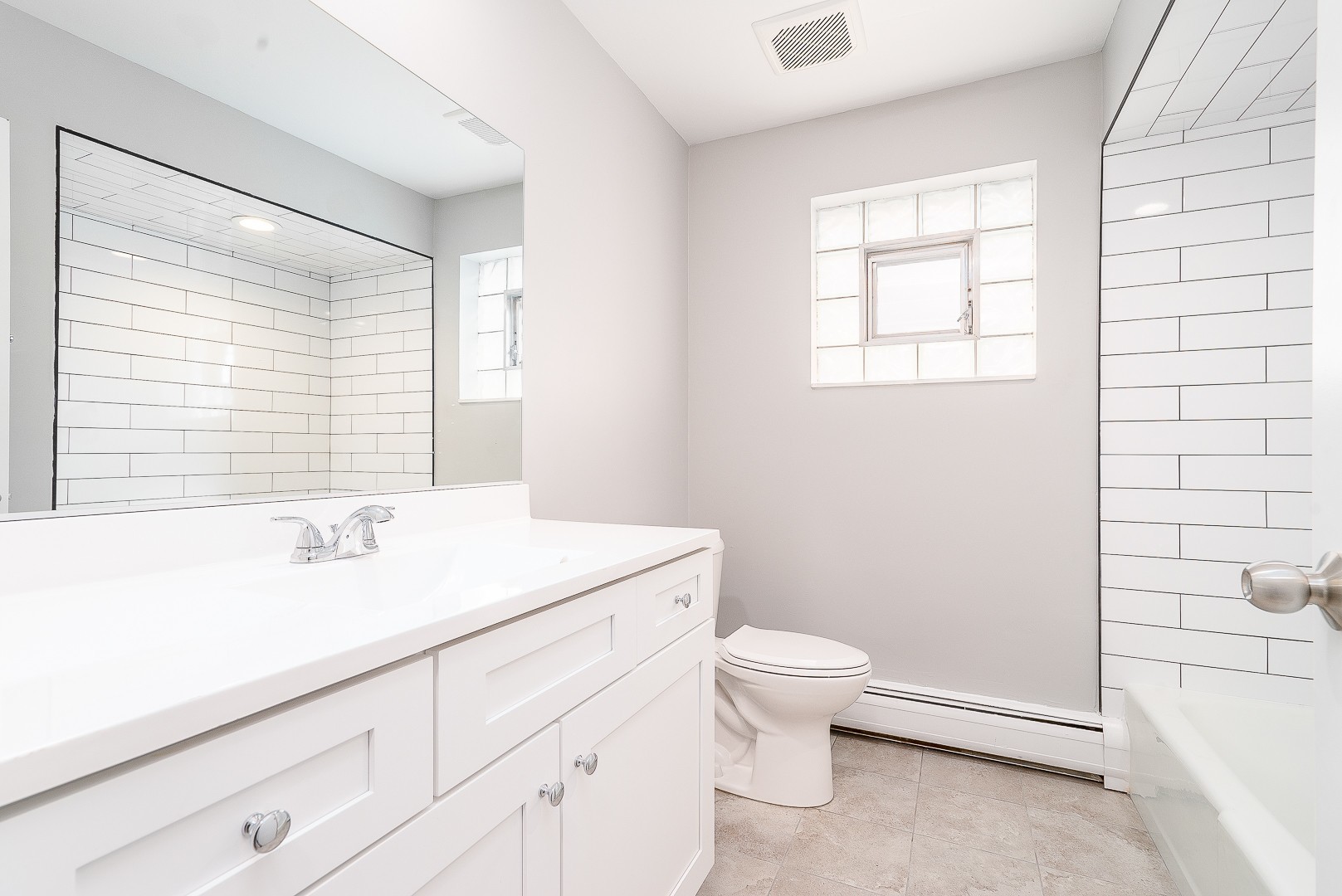 27 South Spring Avenue, Unit 2 La Grange, IL 60525 - Photo 2 of 13 a bathroom with a sink a toilet and a window