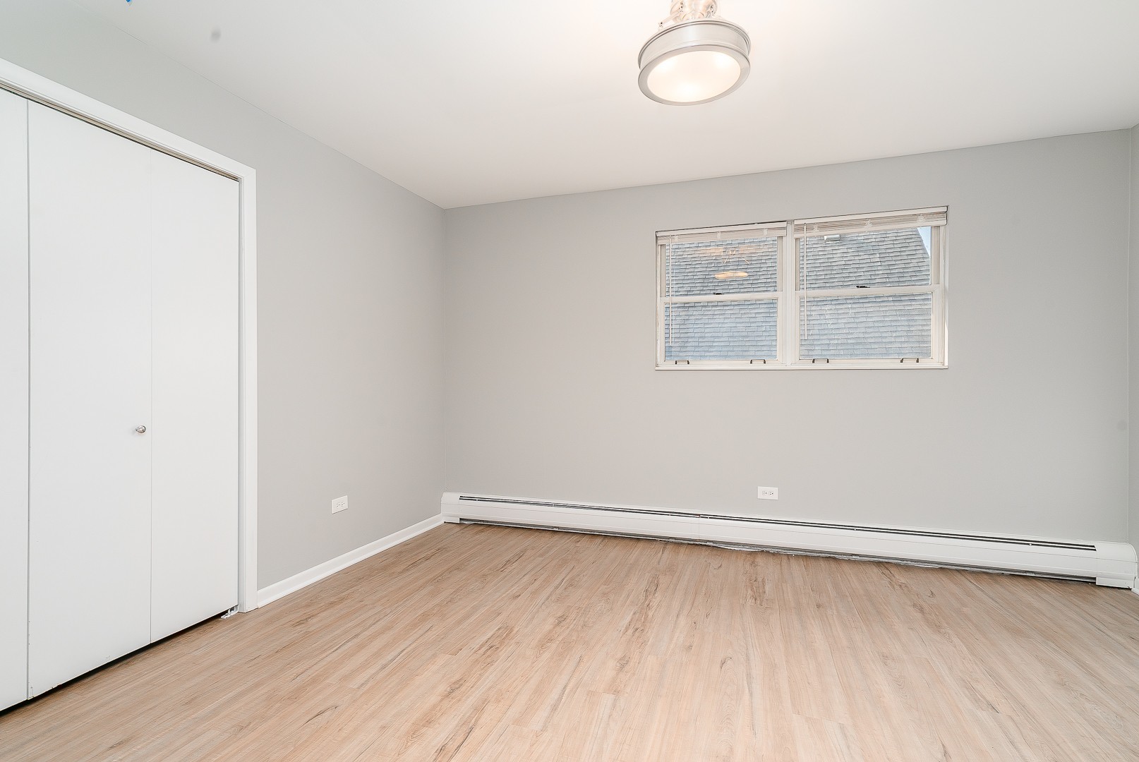 27 South Spring Avenue, Unit 2 La Grange, IL 60525 - Photo 3 of 13 an empty room with wooden floor and windows