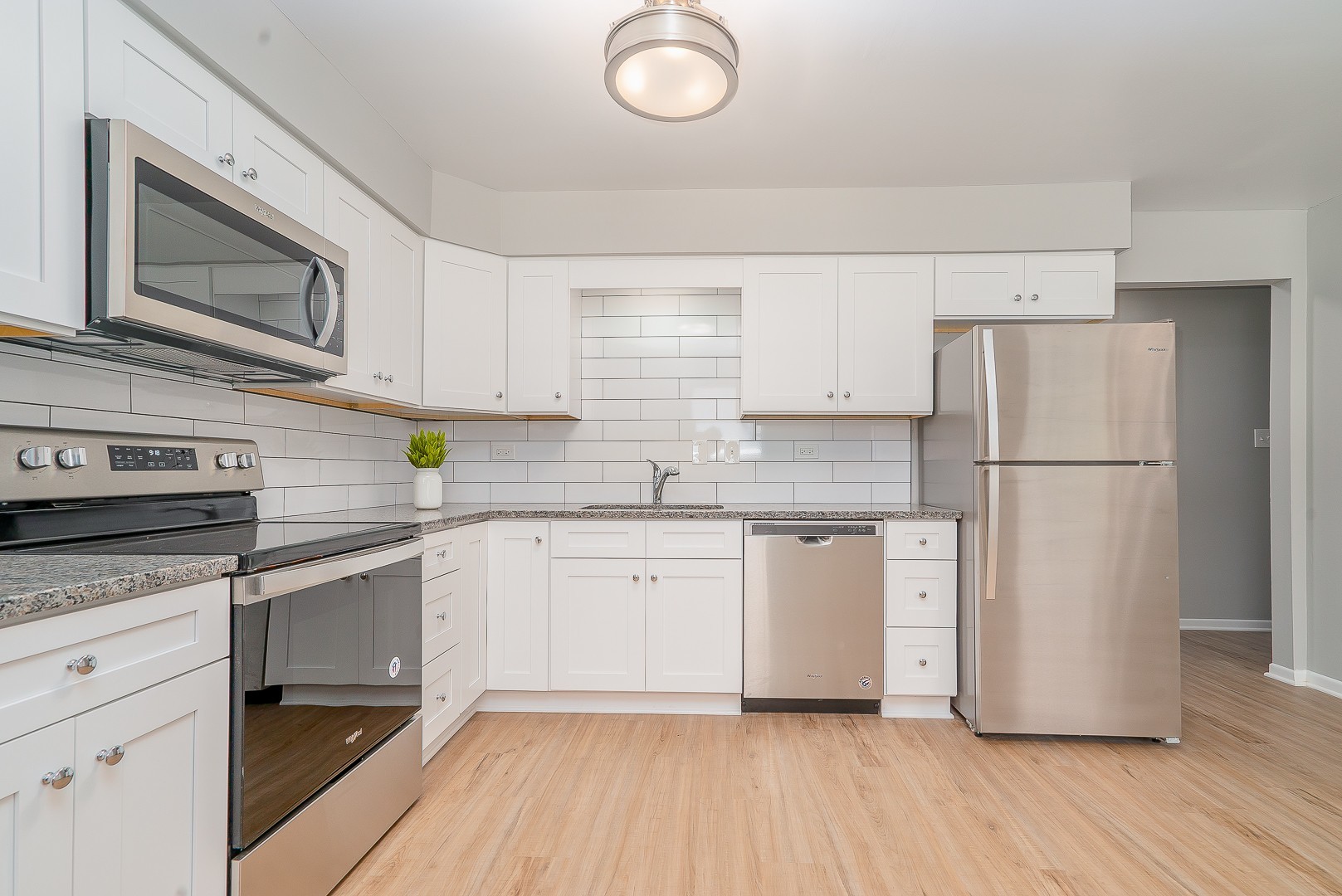 27 South Spring Avenue, Unit 2 La Grange, IL 60525 - Photo 5 of 13 a kitchen with granite countertop a refrigerator stove and sink