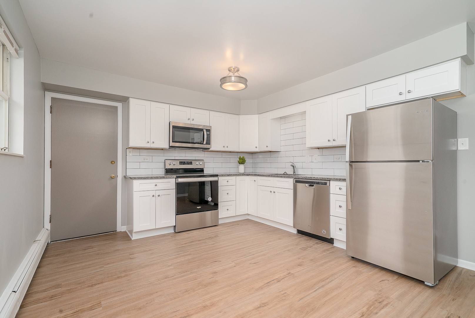 27 South Spring Avenue, Unit 2 La Grange, IL 60525 - Photo 10 of 13 a kitchen with a refrigerator a stove top oven a sink and cabinets