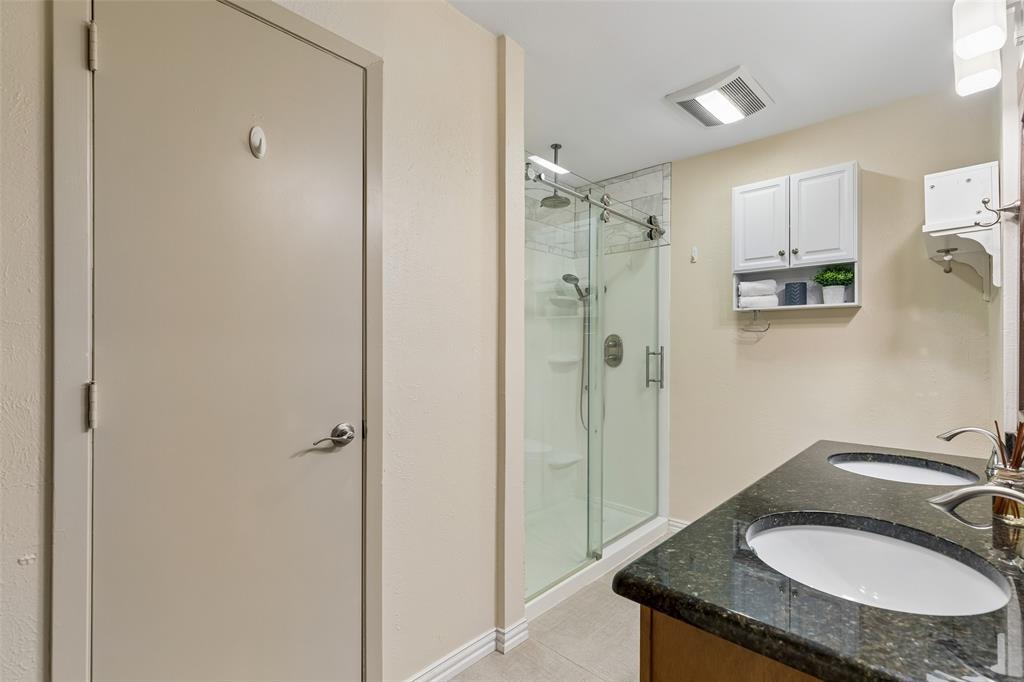 1548 Timbercreek Drive Howe, TX 75459 - Photo 21 of 24 a bathroom with a granite countertop sink shower and a mirror