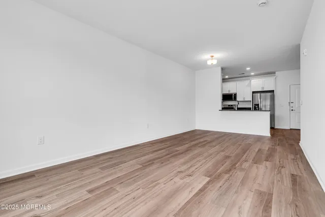 a view of a kitchen with wooden floor and a sink